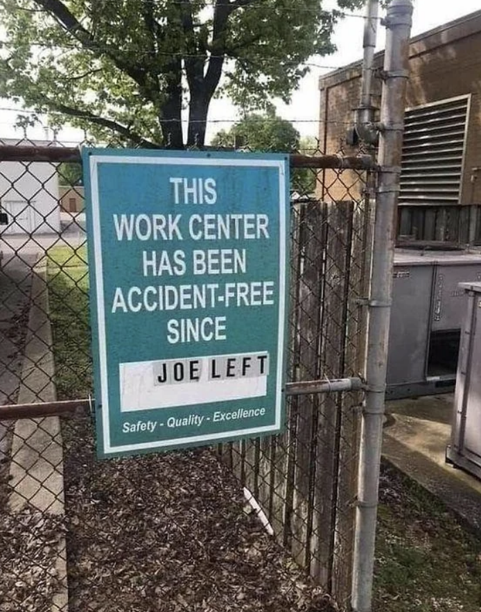 Sign states &quot;This work center has been accident-free since Joe left&quot; with safety and quality excellence slogans below