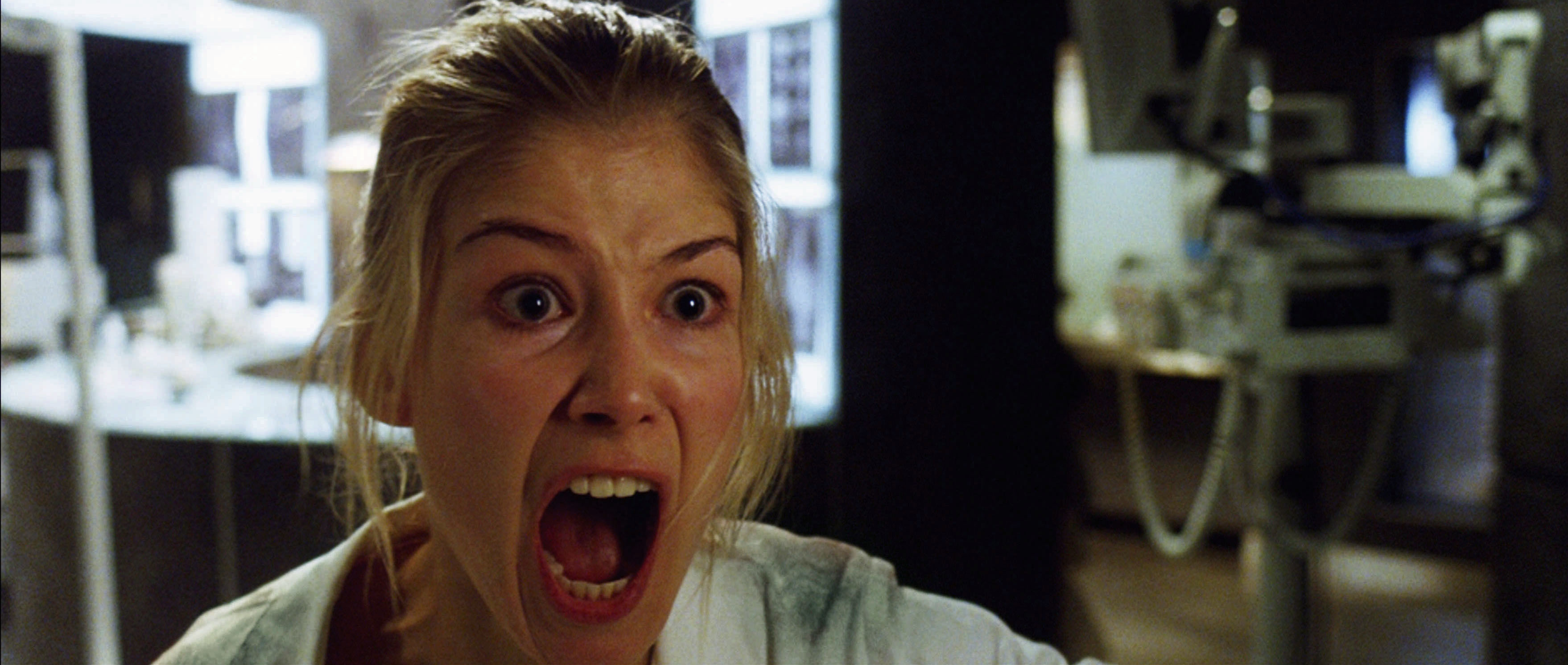 in a scene, Rosamund with a terrified expression, screaming, in a clinical setting