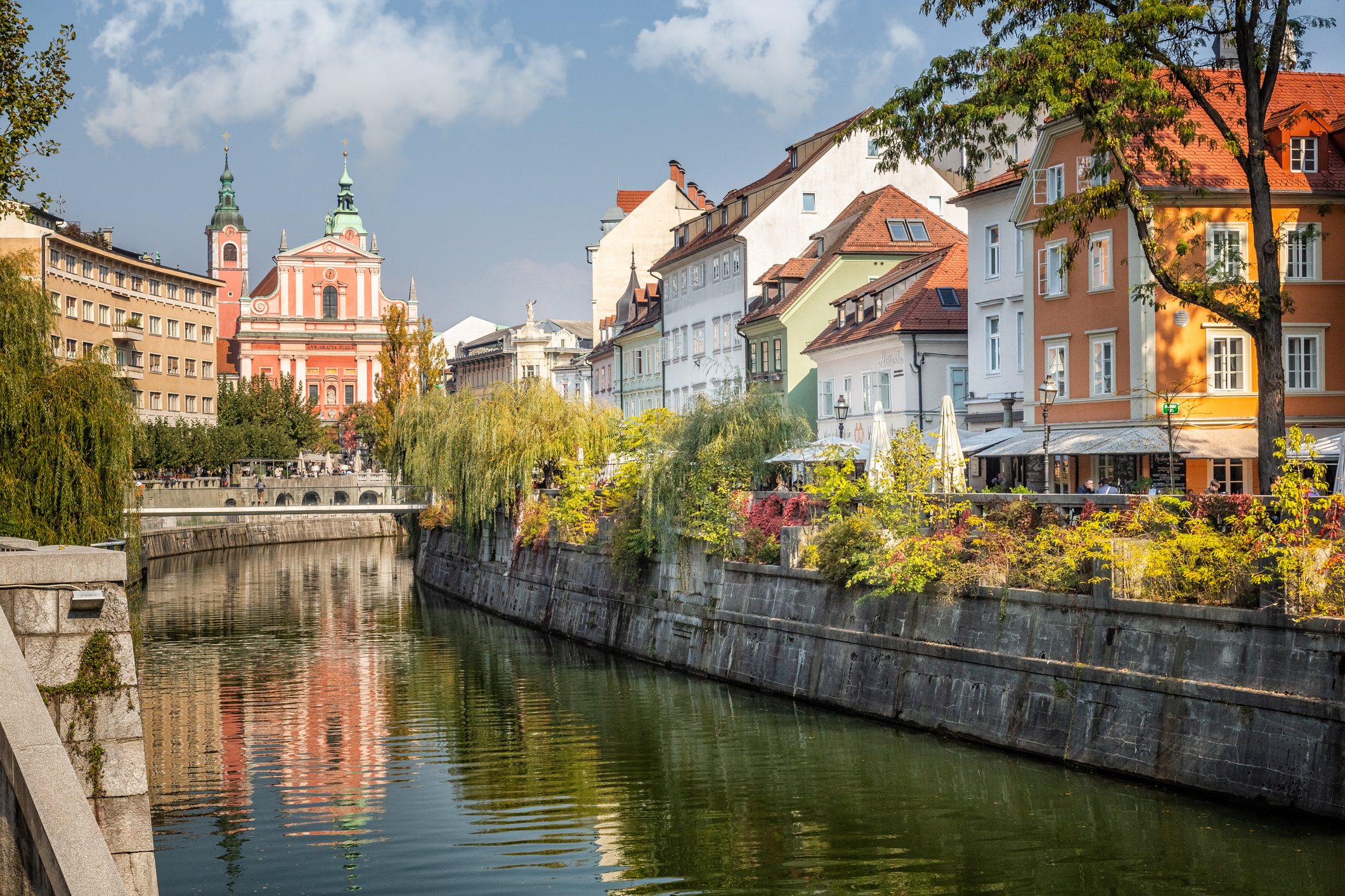 View of Ljubljana’s canal with historic buildings and the Franciscan Church of the Annunciation