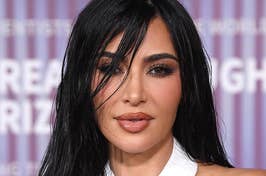Portrait of Kim Kardashian in a white crisscross halter top at an event