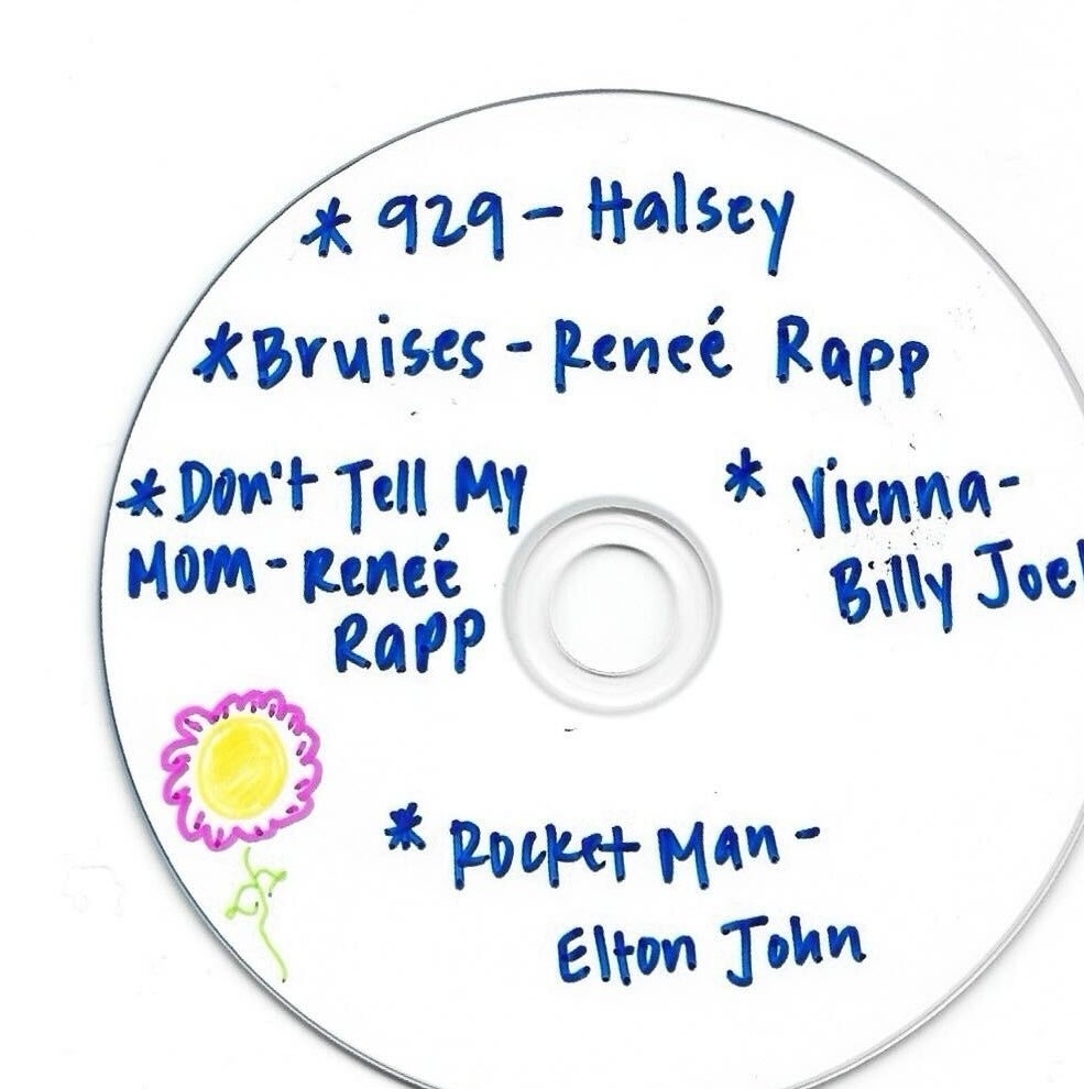 A handwritten CD with song titles from Halsey, Renée Rapp, Billy Joel, and Elton John