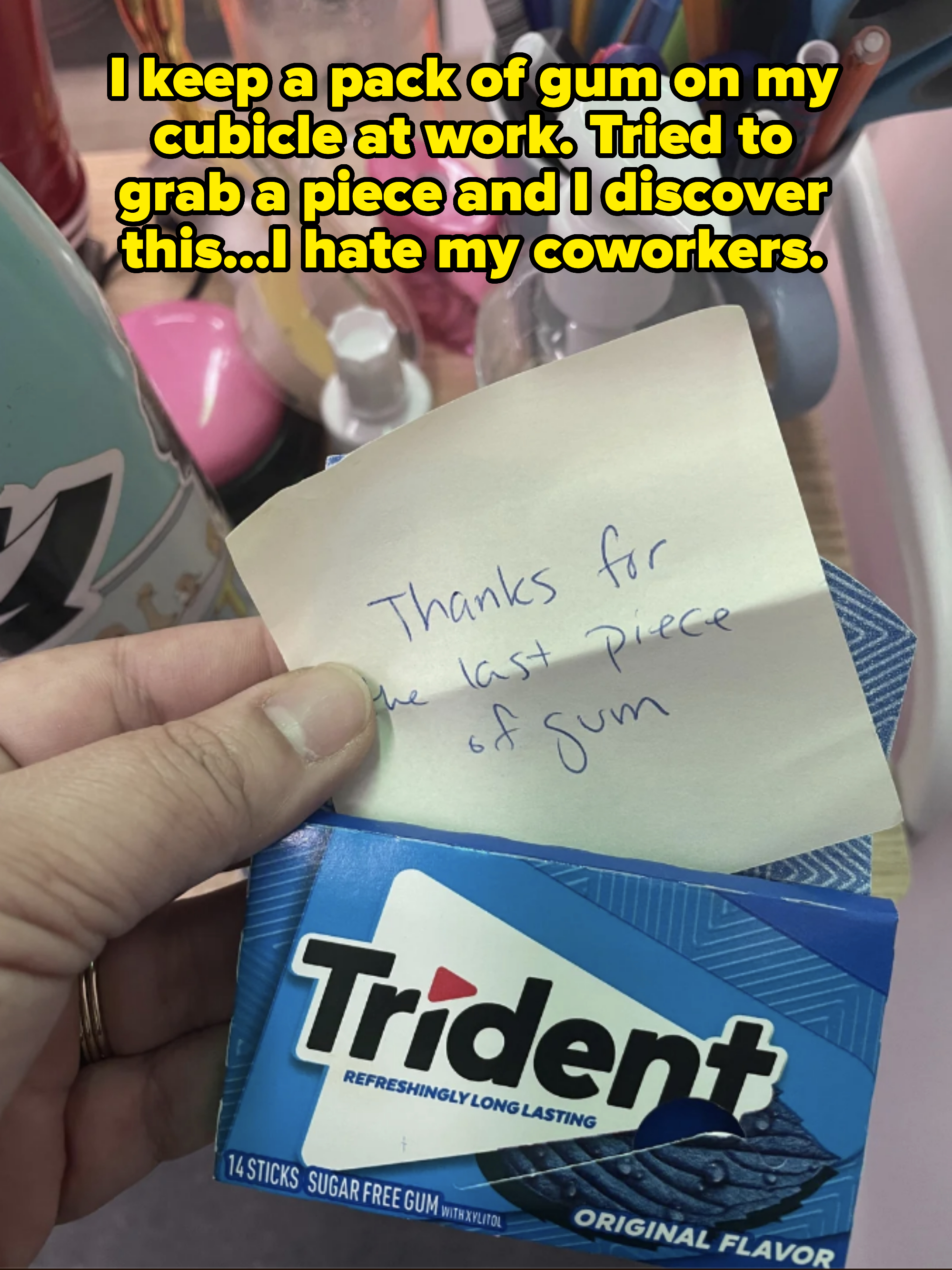 A note saying &quot;Thanks for the last piece of gum&quot; placed on a Trident gum pack, surrounded by office supplies
