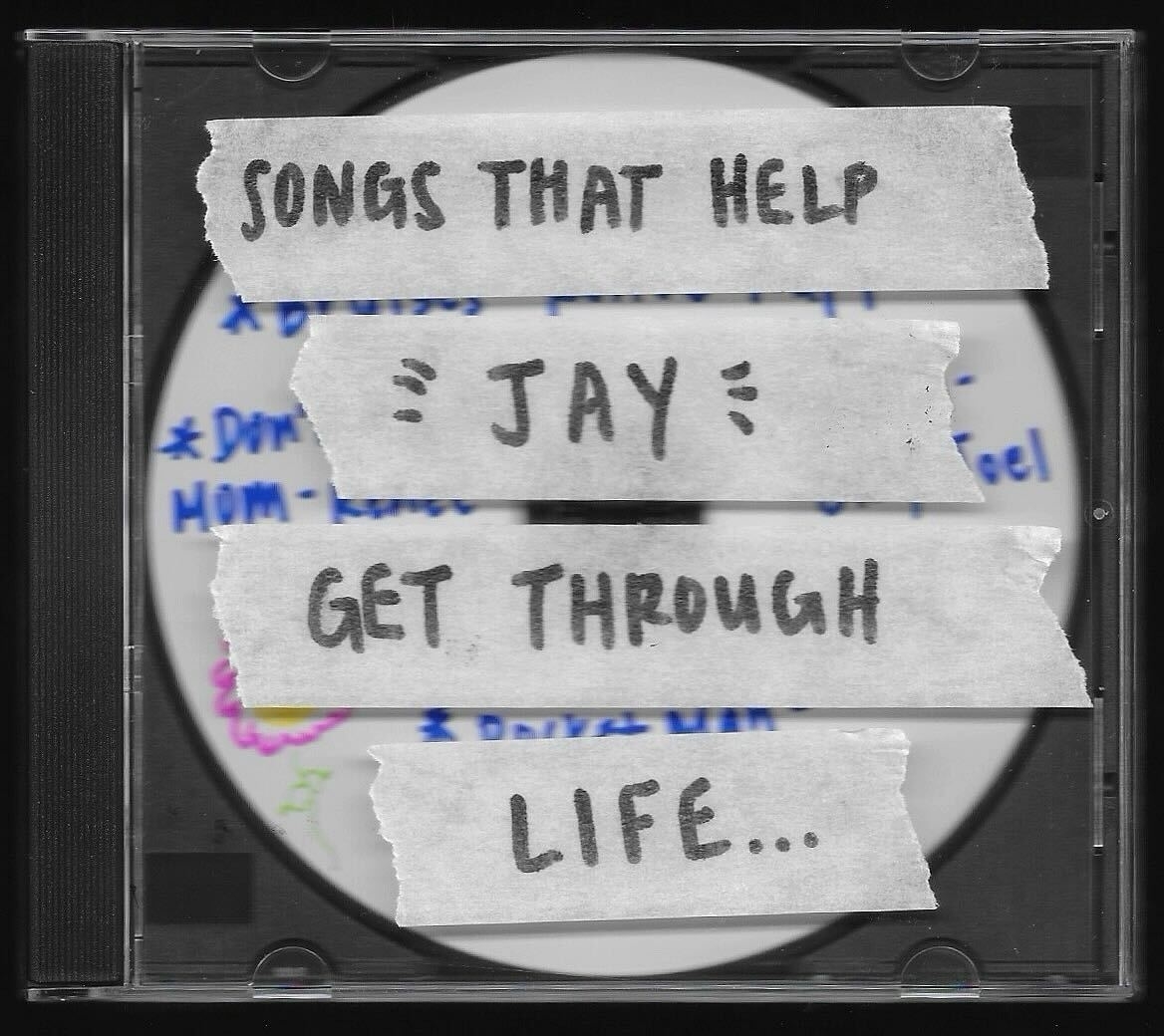 CD case labeled &quot;SONGS THAT HELP GET THROUGH LIFE&quot; with a name written in the center, surrounded by hearts