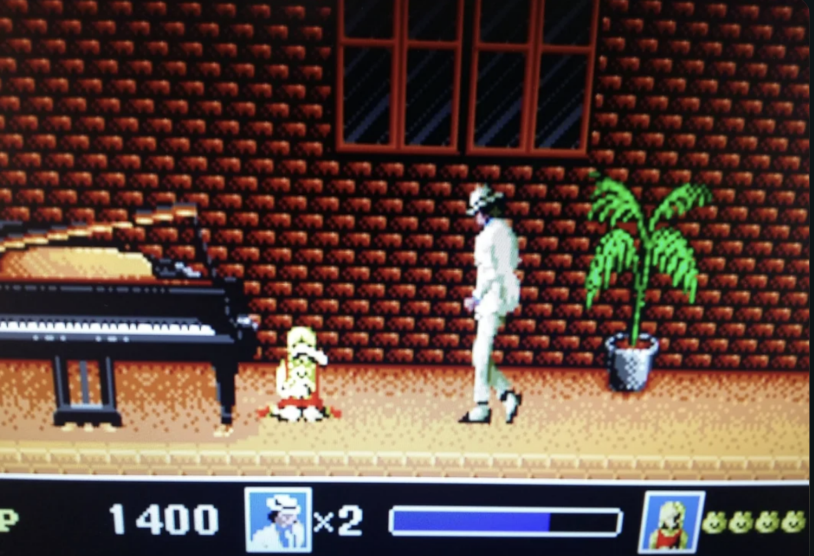A scene from the Michael Jackson&#x27;s Moonwalker video game showing Michael in a white suit with his pet chimp, Bubbles