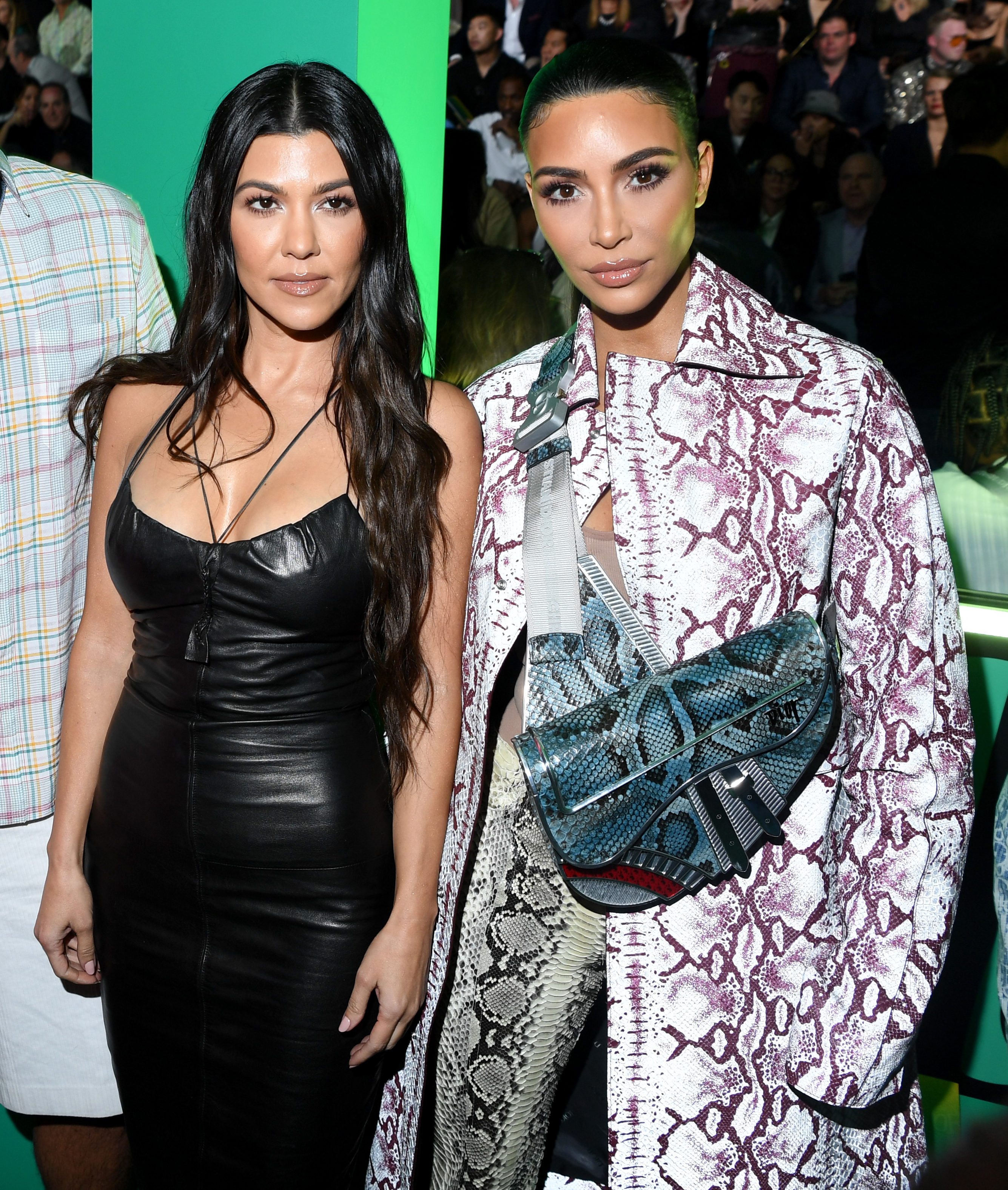 Closeup of Kourtney Kardashian Barker and Kim Kardashian at an event