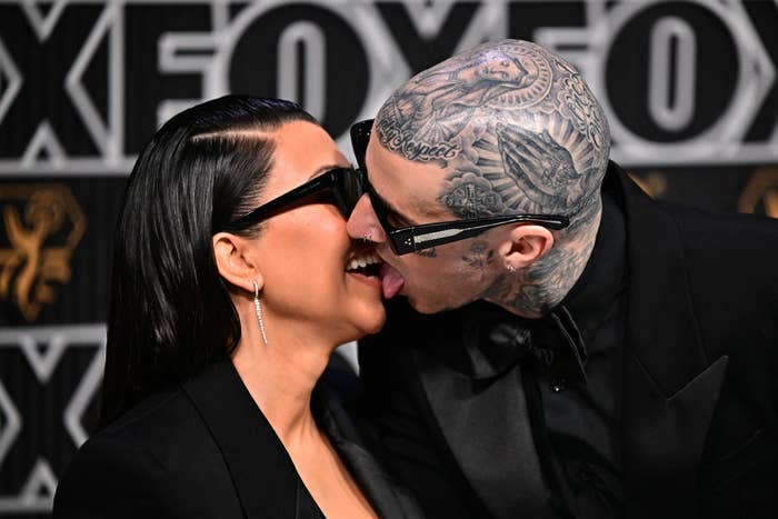 Kim Kardashian and Travis Barker leaning in for a kiss
