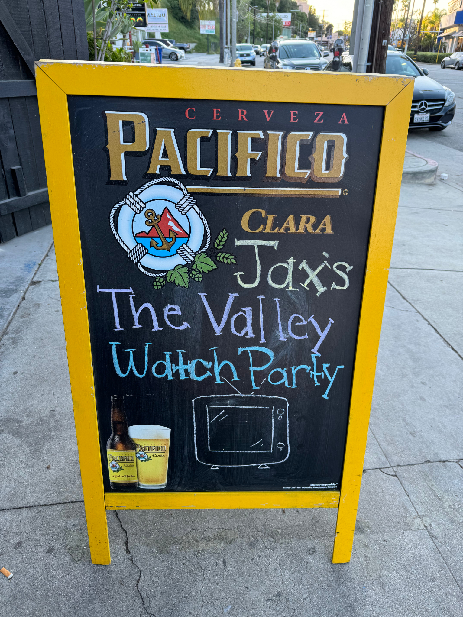 Sidewalk sign advertising Pacifico beer and promoting Jaxi&#x27;s The Valley Watch Party