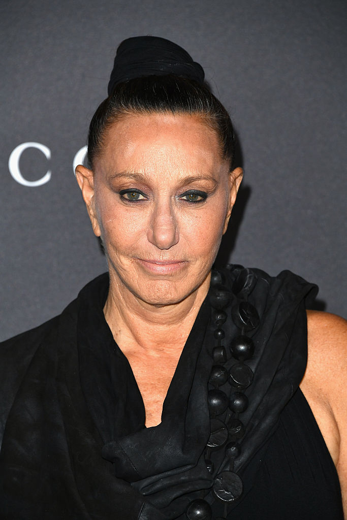 Donna Karan in a black outfit with statement necklace at an event