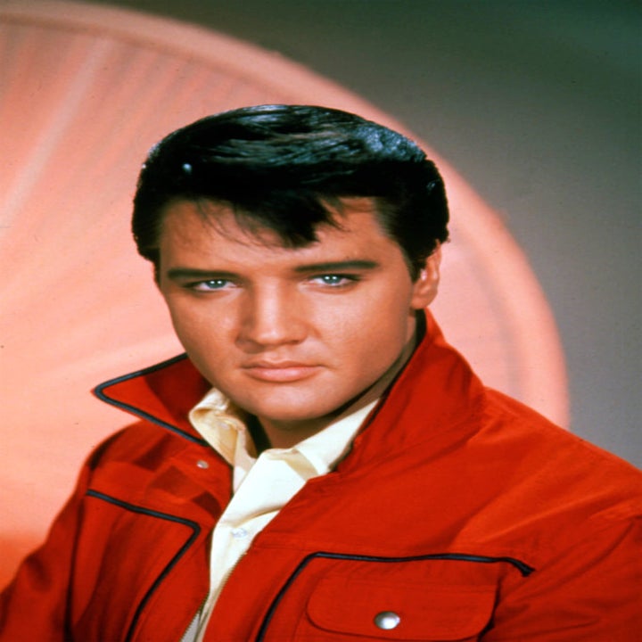Elvis Presley posing in a red jacket, looking at the camera. Vintage portrait for a throwback article