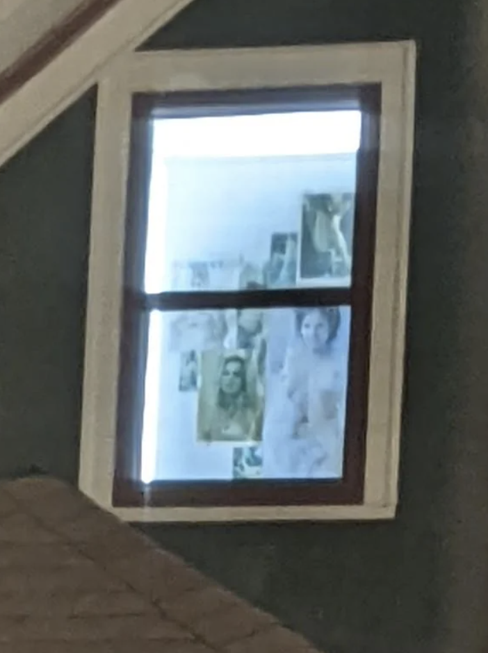 A window showcasing a collage of various photographs, with discernible images of people