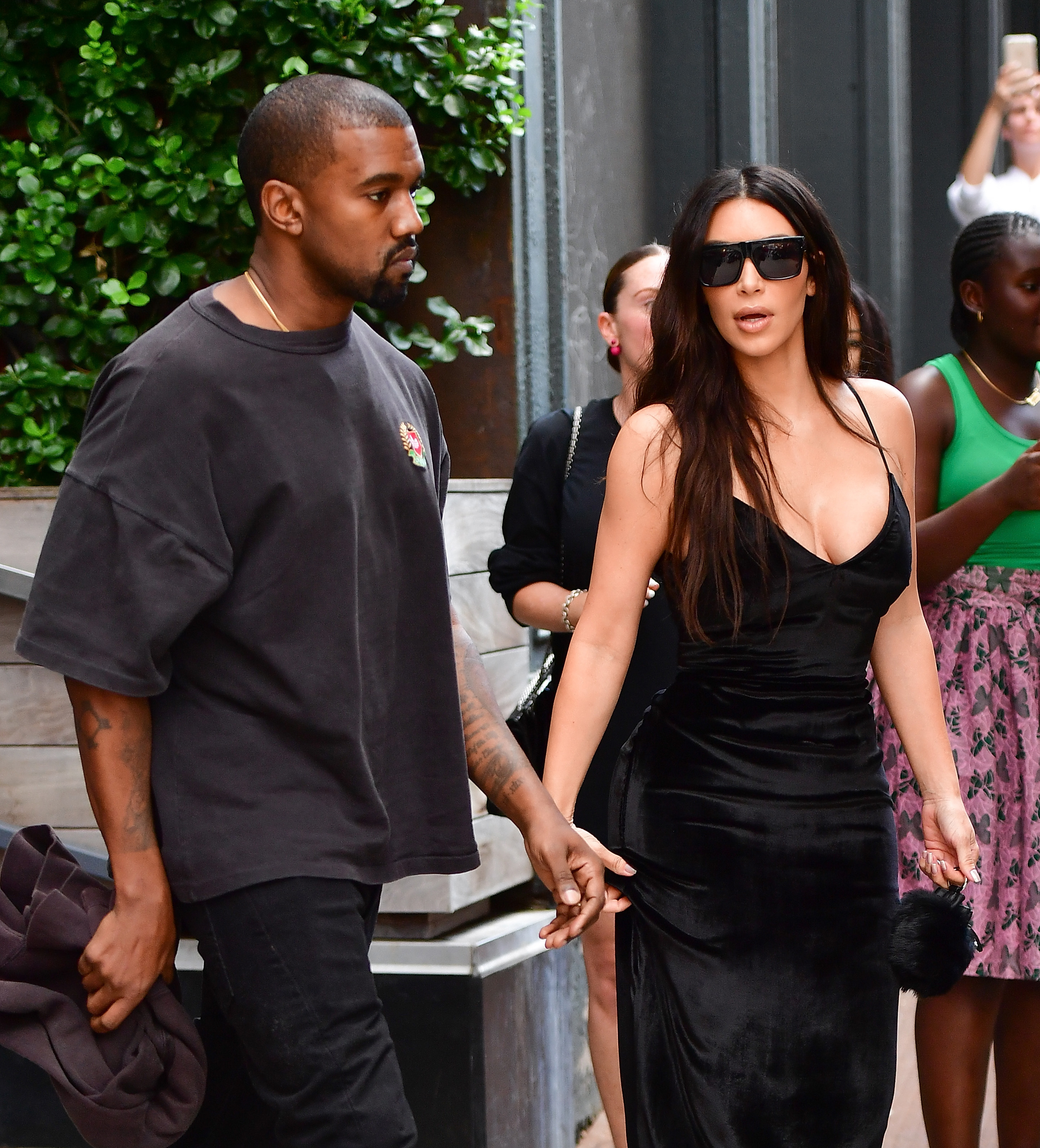 Kanye West and Kim Kardashian walking hand in hand