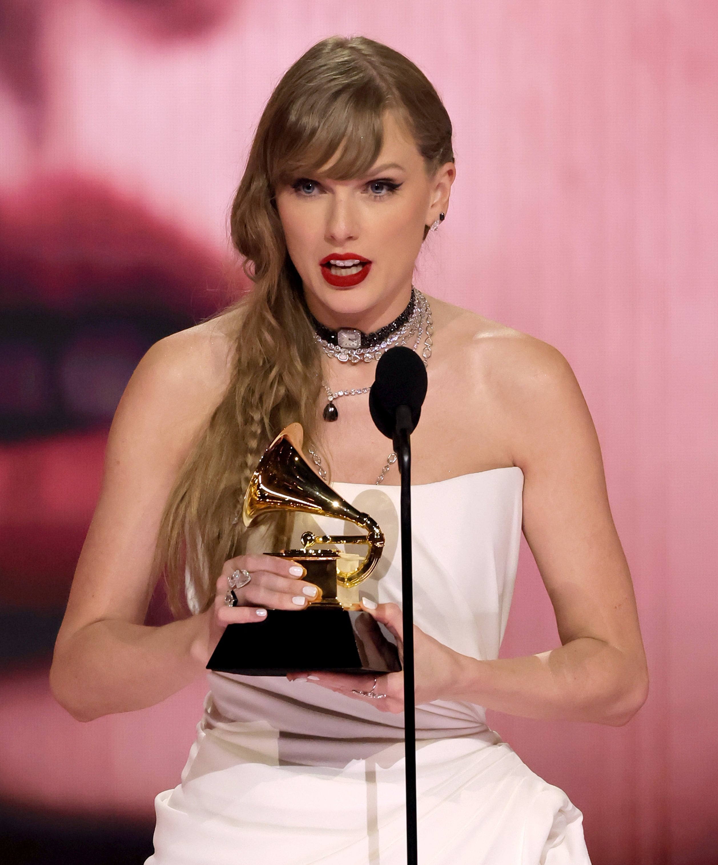 Taylor holding a Grammy award
