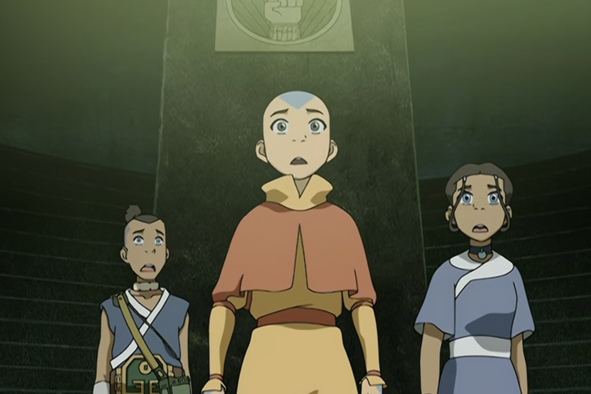 Aang, Sokka, and Katara from Avatar look up in concerned anticipation