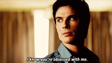 Damon Salvatore from The Vampire Diaries smirking with a caption bubble saying, &quot;I know you're obsessed with me.&quot;