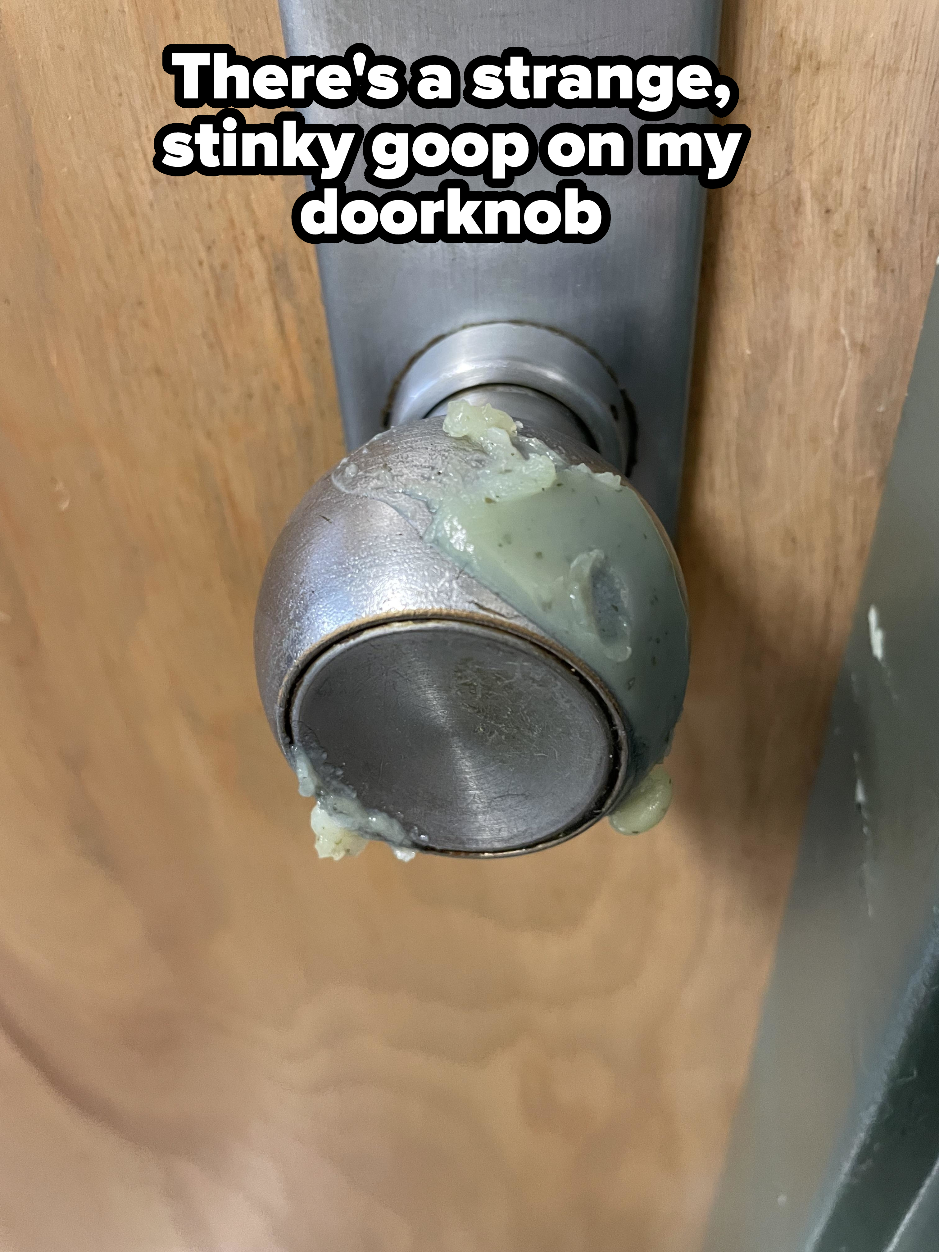 A doorknob with a sticky green substance on it