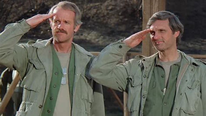 Two characters from M*A*S*H, in military attire, saluting