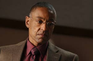 Gus Fring from Breaking Bad in a suit and tie, looking pensive