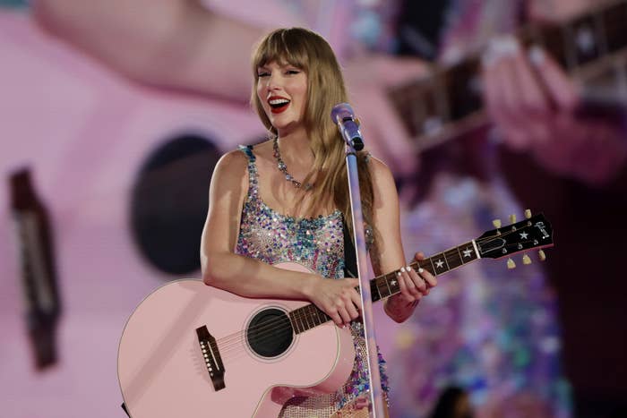 Taylor Swift performs onstage with a glittery outfit and guitar
