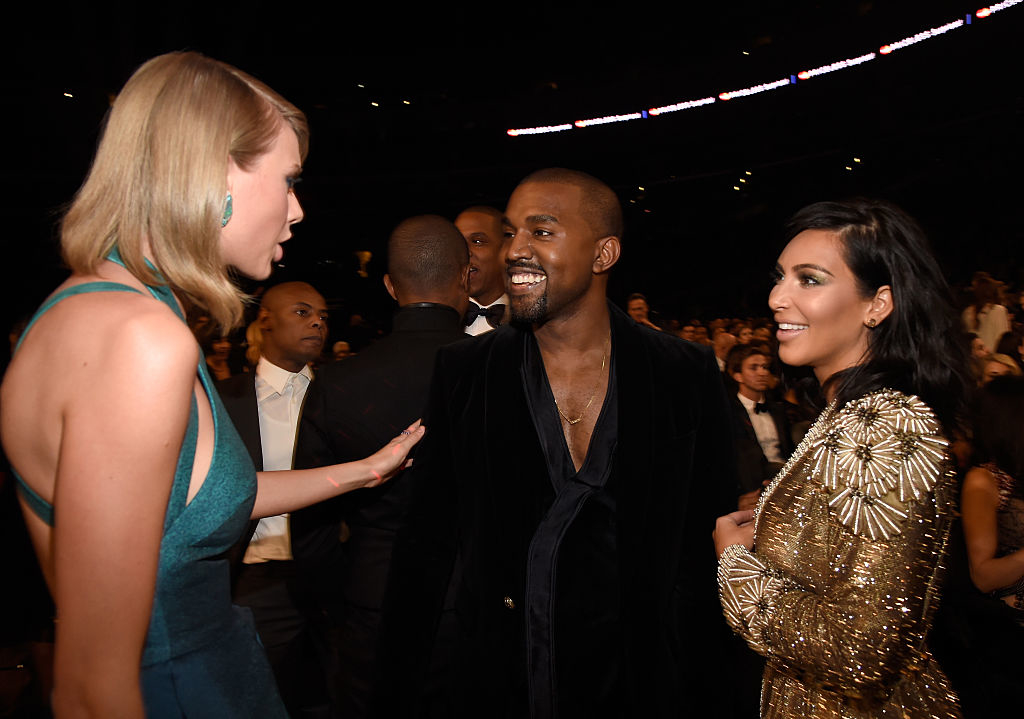 Taylor Swift, Kanye West, and Kim Kardashian conversing at an awards show