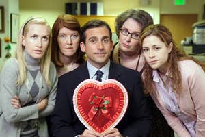 Office TV show charactas posin wit Mike Scott holdin a heart-shaped box
