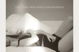 Taylor Swift lying on the bed in the Tortured Poets Department album cover
