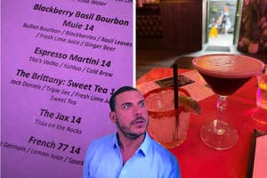 Man looking up at a cocktail menu with various drink names and ingredients