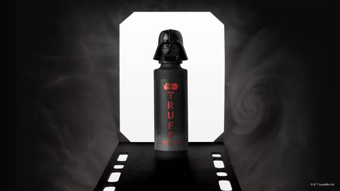 Darth Vader themed water bottle with &quot;Star Wars&quot; and &quot;TRUFFLE&quot; text, spotlighted between smoke swirls against a dark backdrop