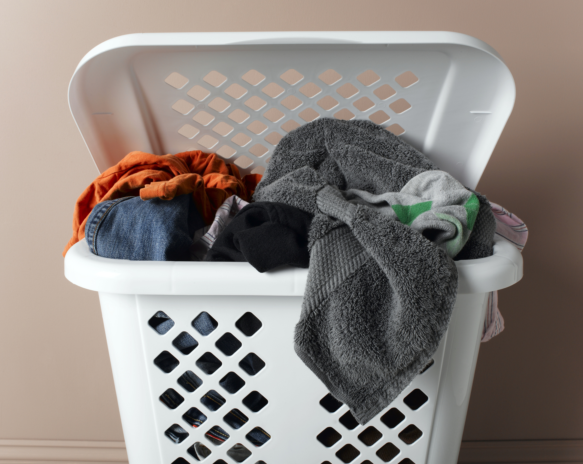 A laundry basket filled with various clothes