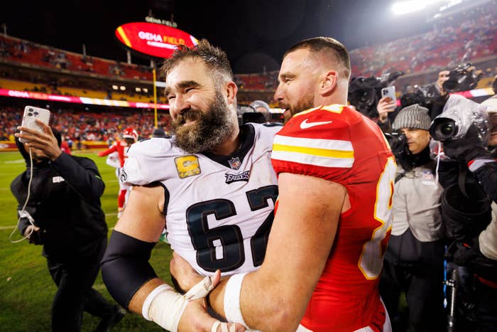 Closeup of Jason and Travis Kelce hugging on the football field