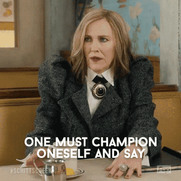 Moira Rose in a textured jacket with a statement brooch, caption: &quot;One must champion oneself and say&hellip;&quot;