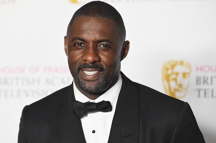 Idris Elba wearing a classic black tuxedo and bow tie at an awards event