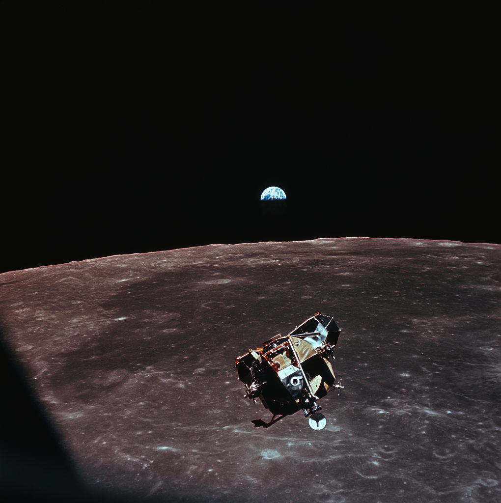Lunar module ascends from moon&#x27;s surface with Earth in the background