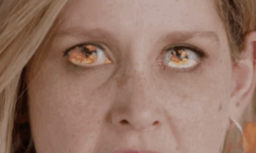 Close-up of a person&#x27;s face with eyes edited to look like flames, possibly representing intense passion or love