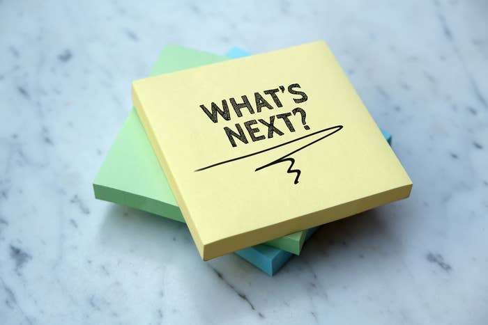 Stack of sticky notes with &quot;WHAT&#x27;S NEXT?&quot; written on the top one, symbolizing anticipation or planning