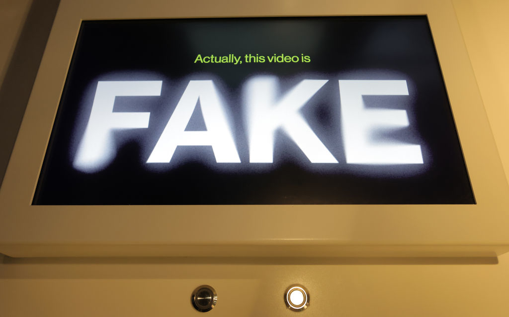 Monitor displaying the message &quot;Actually, this video is FAKE&quot; to indicate counterfeit content