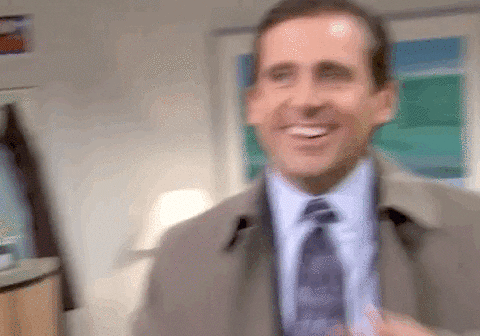 Character Michael Scott from The Office mimicking a phone call with his shoe