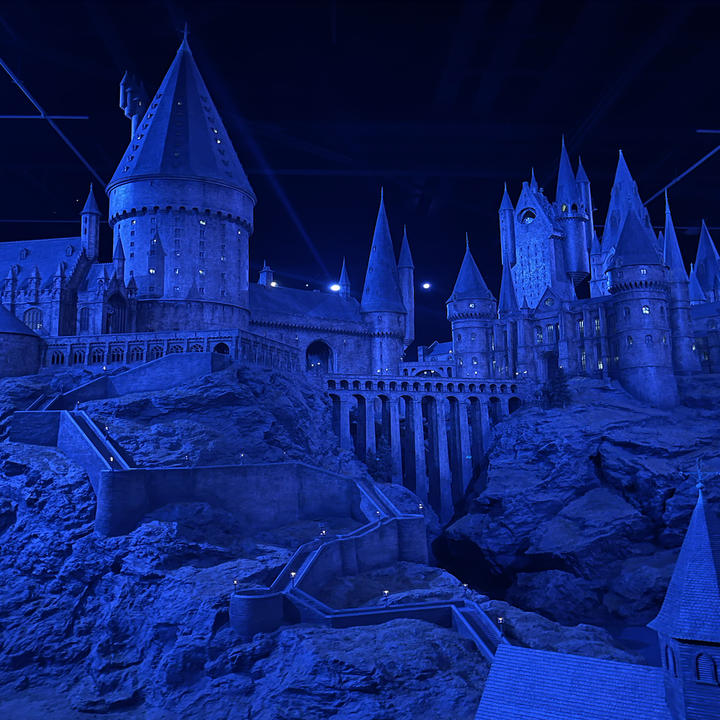 Hogwarts Castle model display from Harry Potter series, shown under blue lighting with intricate architectural details