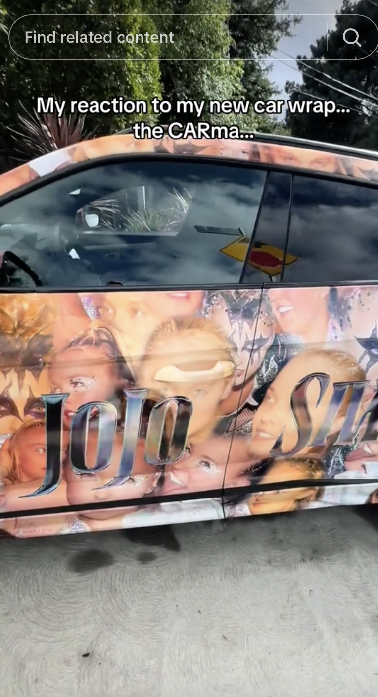 Car wrapped with images of JoJo Siwa, including her name, parked outside