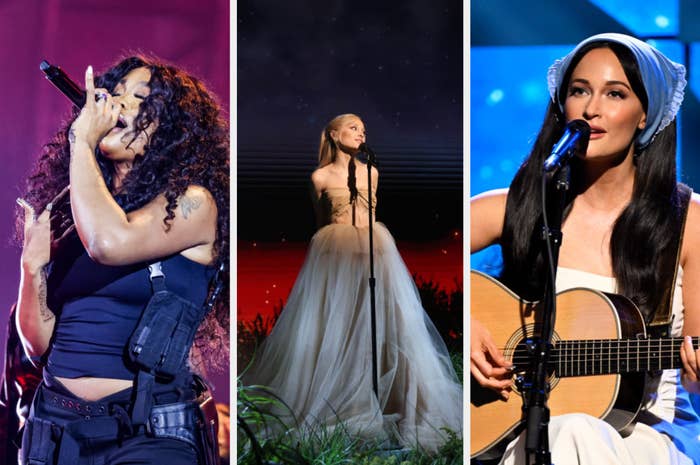 Three female artists performing on stage; first singing into mic, second in a flowing dress, third playing guitar