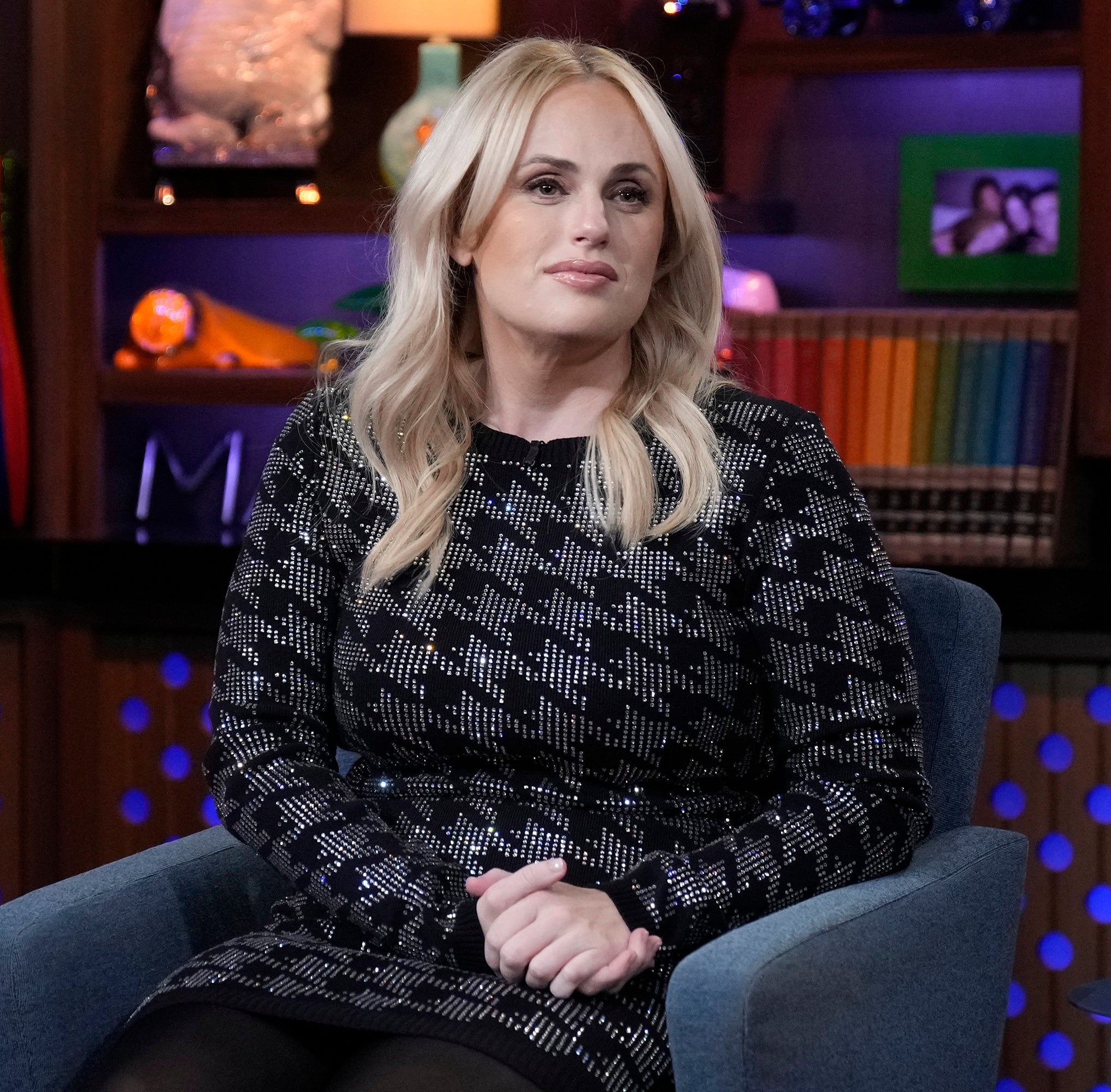 Rebel in a patterned dress sitting on a talk show set