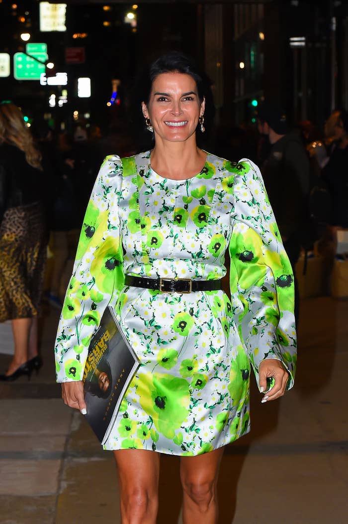 Angie Harmon at event wearing a floral print dress with a belted waist