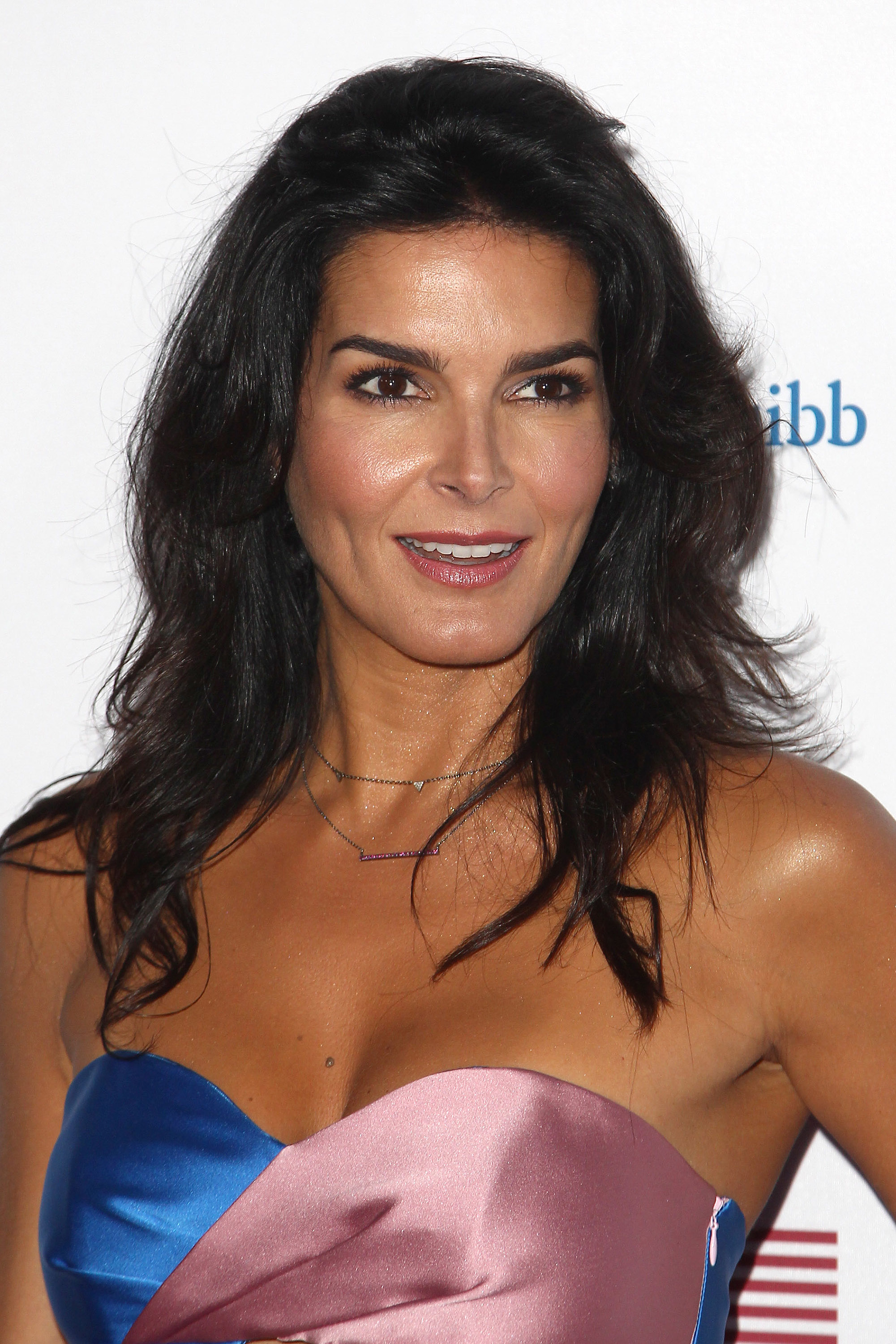 A closeup of Angie Harmon on the red carpet in a strapless outfit