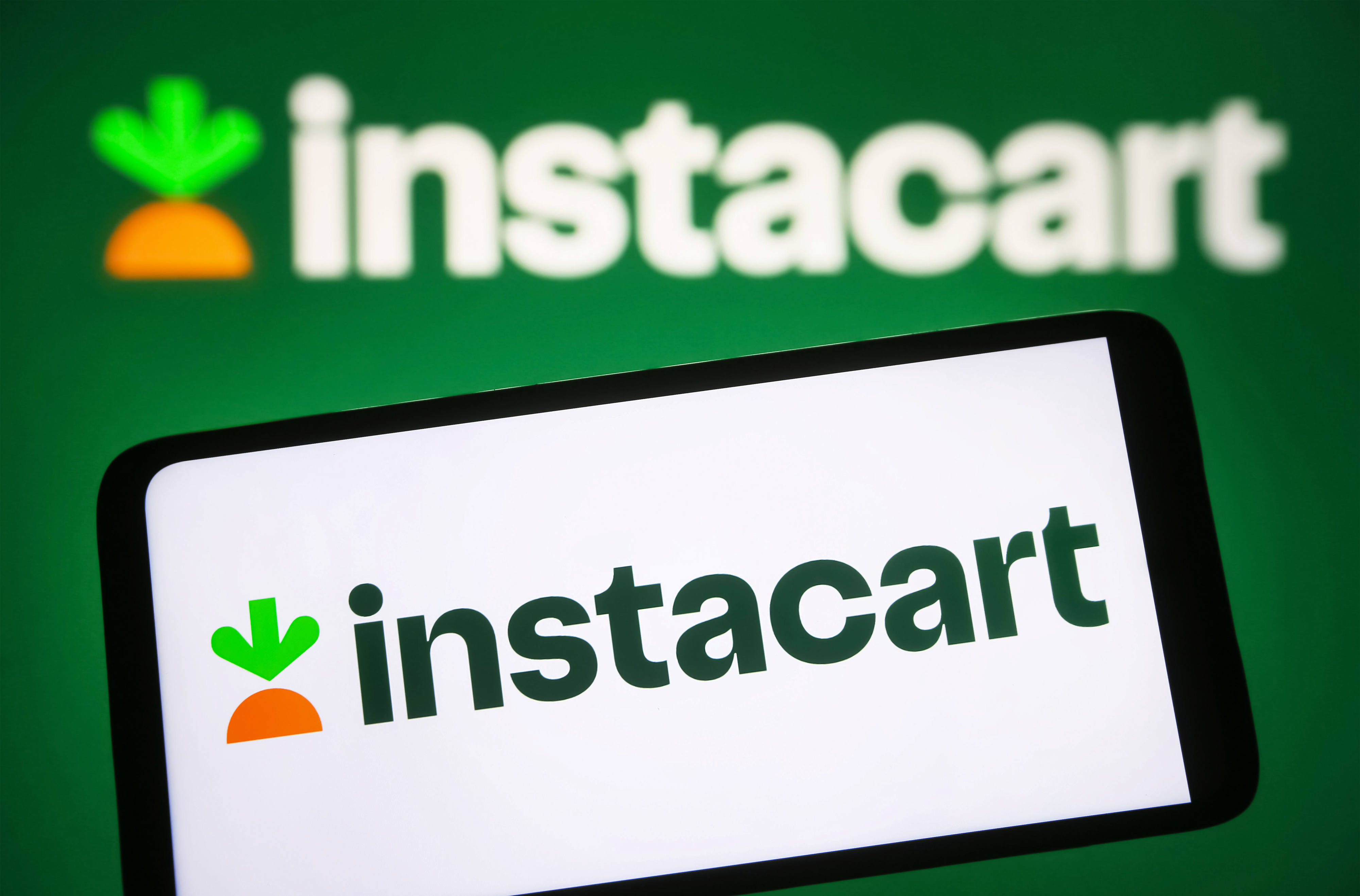 Instacart logo on a digital screen with a carrot icon above the brand name