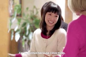 Marie Kondo smiling in a scene with subtitle text: "I'm so excited because I love mess."