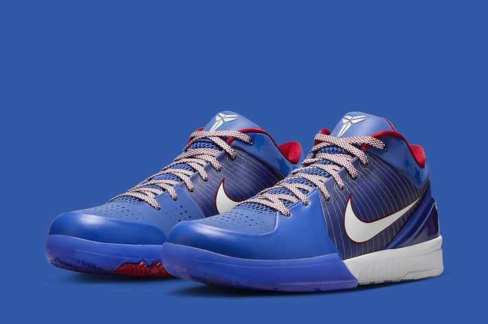 Pair of blue basketball sneakers with white swoosh logo and red accents