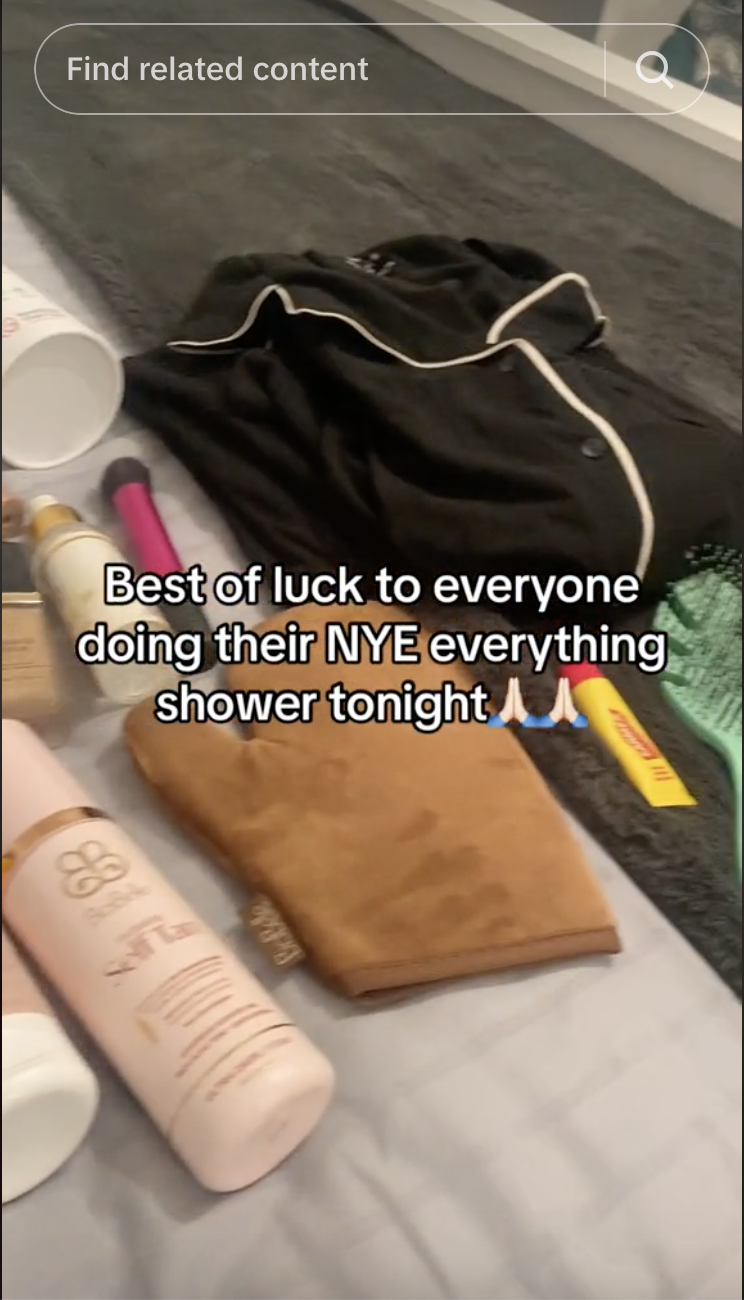 Text over an image of assorted grooming products and a black robe wishing good luck to those taking a New Year&#x27;s Eve shower