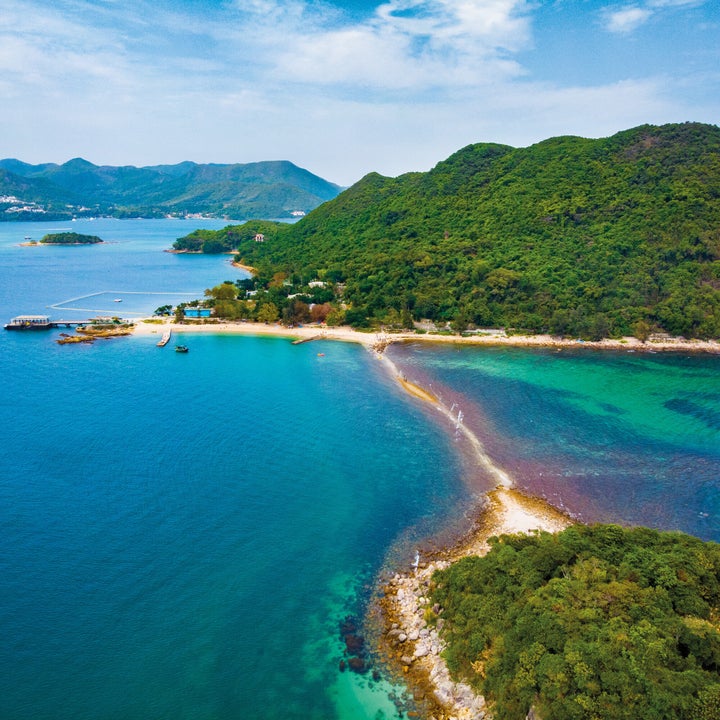 Aerial view of a serene peninsula with beaches and lush greenery