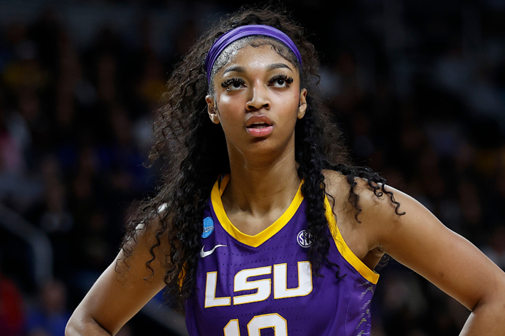 Female basketball player in LSU jersey, focused look during a game