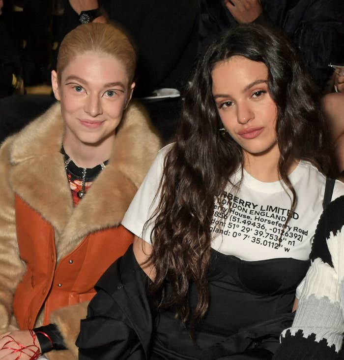 Hunter and Rosalía seated next to each other at an event, one in a fur-trimmed jacket and the other in a graphic tee