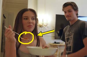 Milly Bobby Brown eating pasta while her husband looks at her